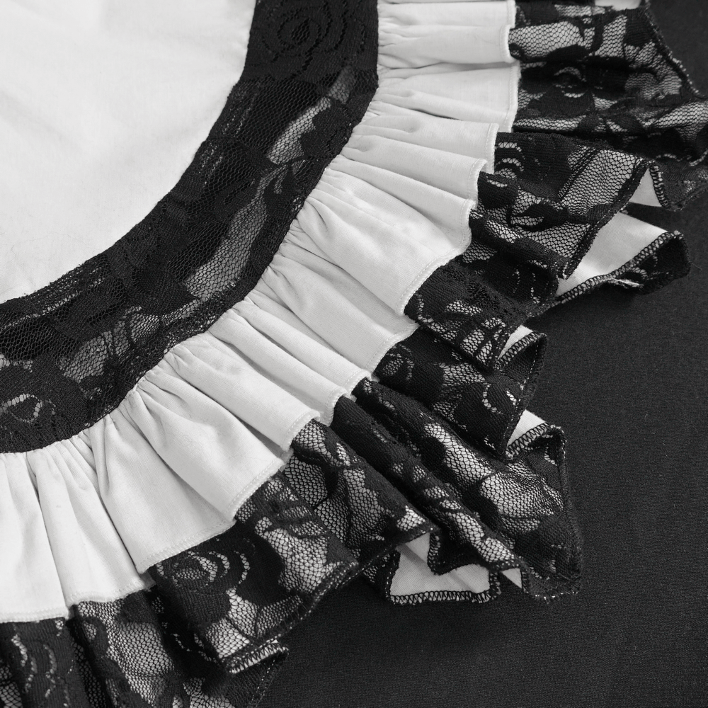 Close-up of Victorian lace ruffle neckline detailing with black tie accents.