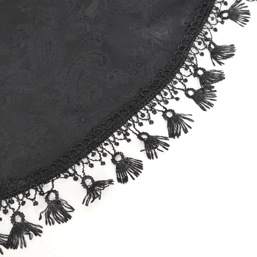 Close-up of intricate black lace fabric with decorative fringed trim, perfect for Victorian Gothic fashion.
