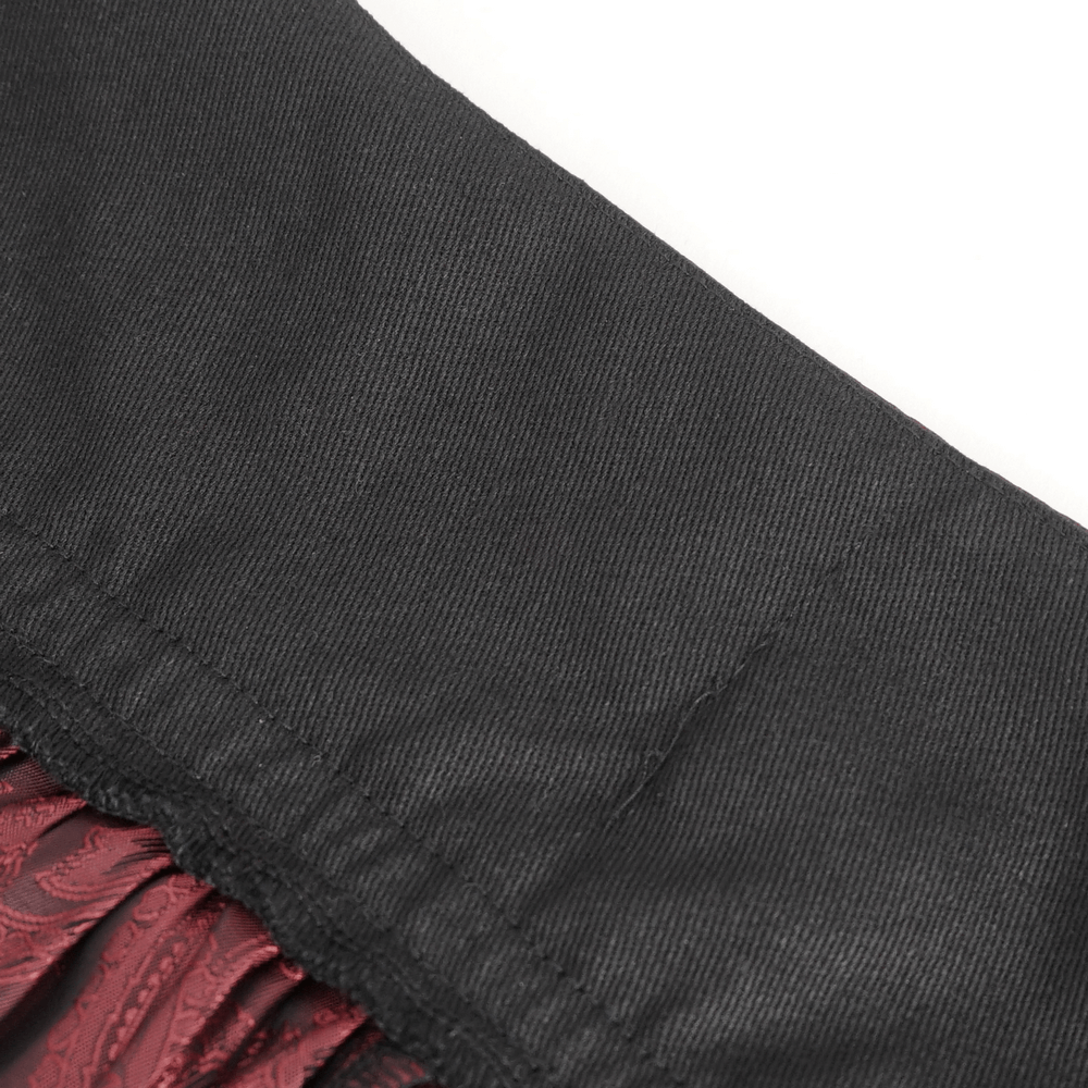 Close-up of the high-waist design of a Victorian Gothic lace skirt with rich black and red ruffled layers.