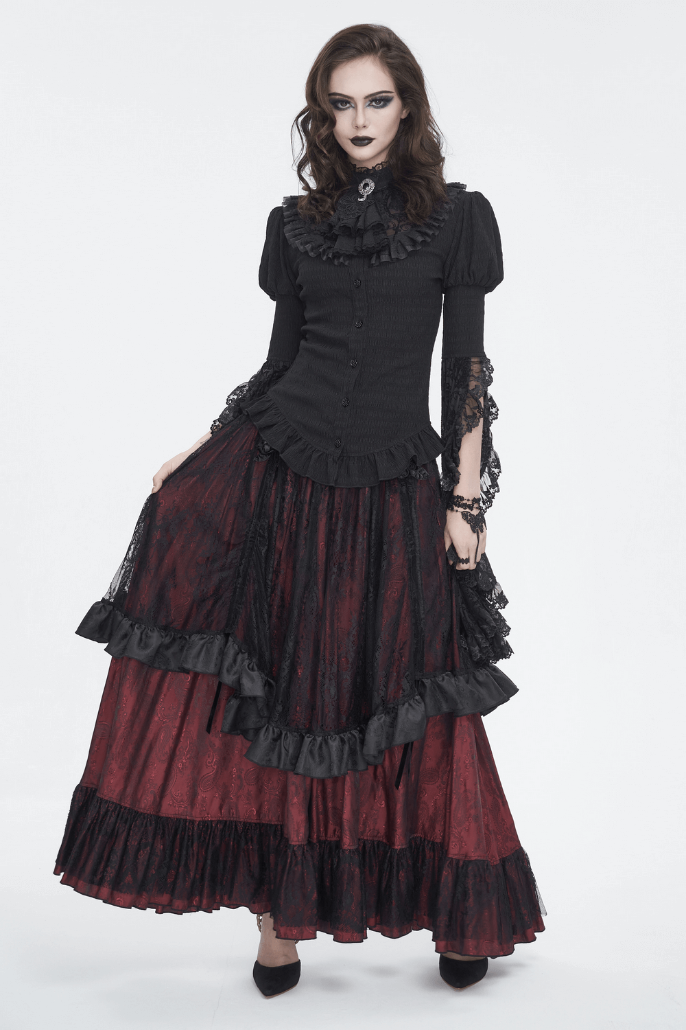 Elegant Victorian Gothic model in ruffled lace skirt, showcasing intricate black and red design with satin bows.
