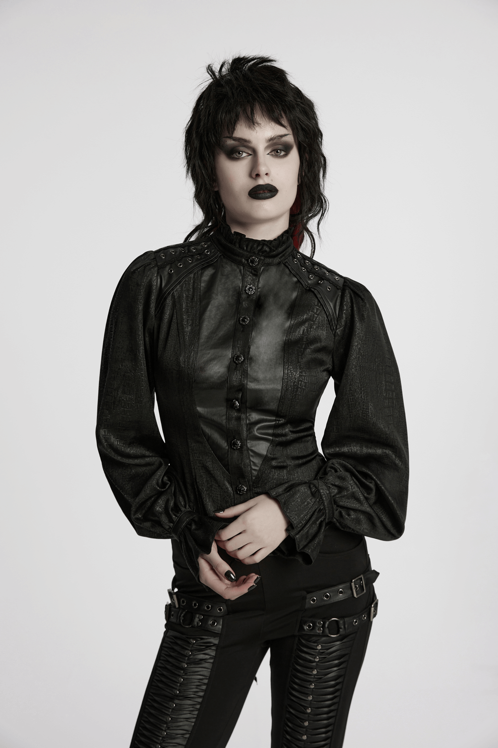 Victorian gothic lace-up blouse with puff sleeves and faux leather panels, showcasing edgy elegance.
