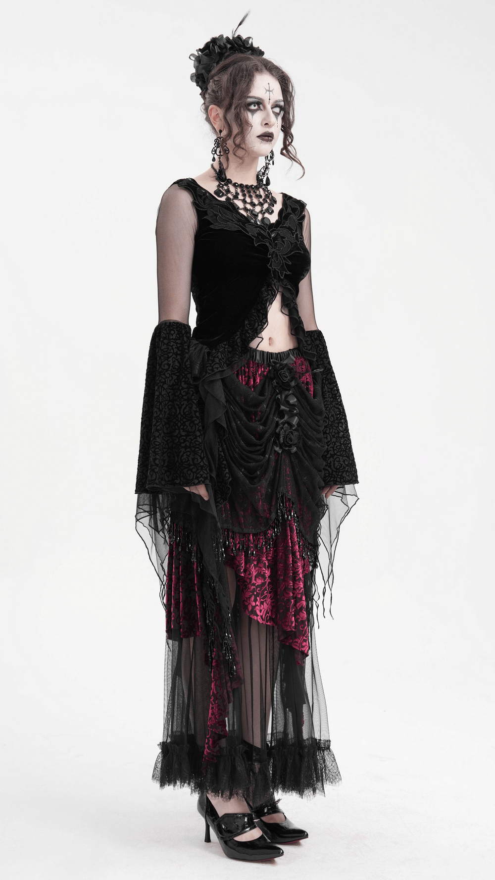 Model wearing a Victorian Gothic layered skirt with lace, beading, and dark elegance in a dramatic outfit.