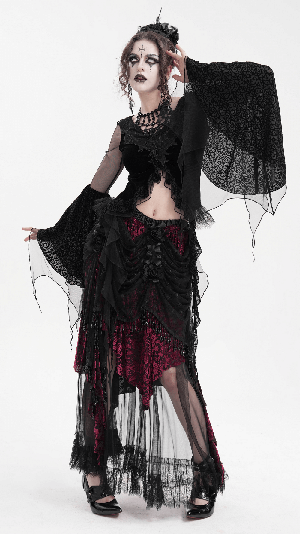 Stunning model showcasing a Victorian Gothic layered skirt with lace, beading, and deep red accents, perfect for alternative fashion.