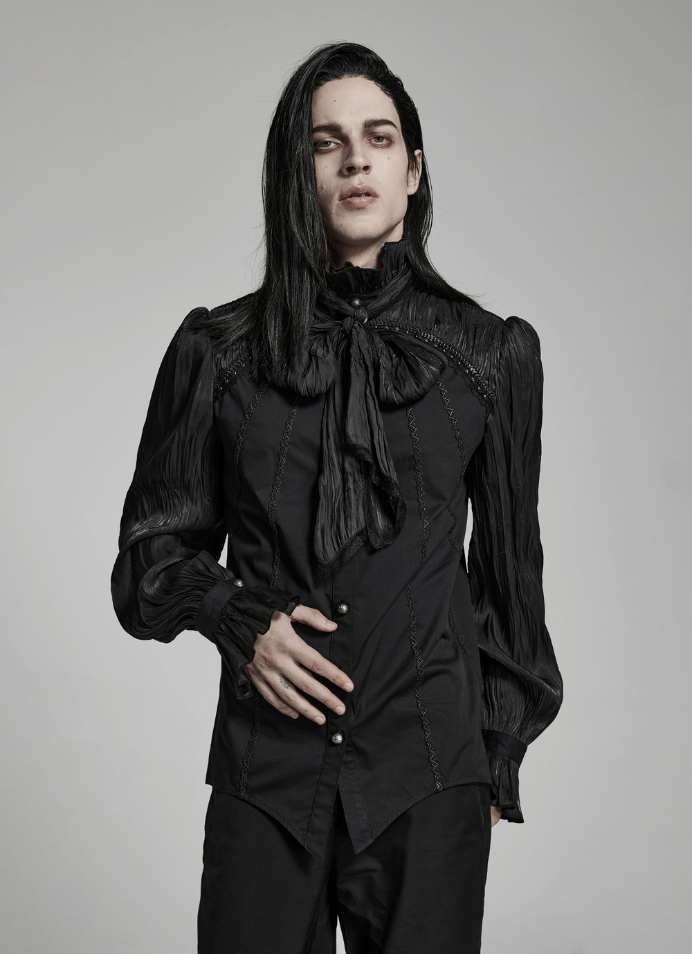 Gothic model wearing a Victorian Gothic Pleated Lace-Up Shirt with lace detailing and shirred shoulders.