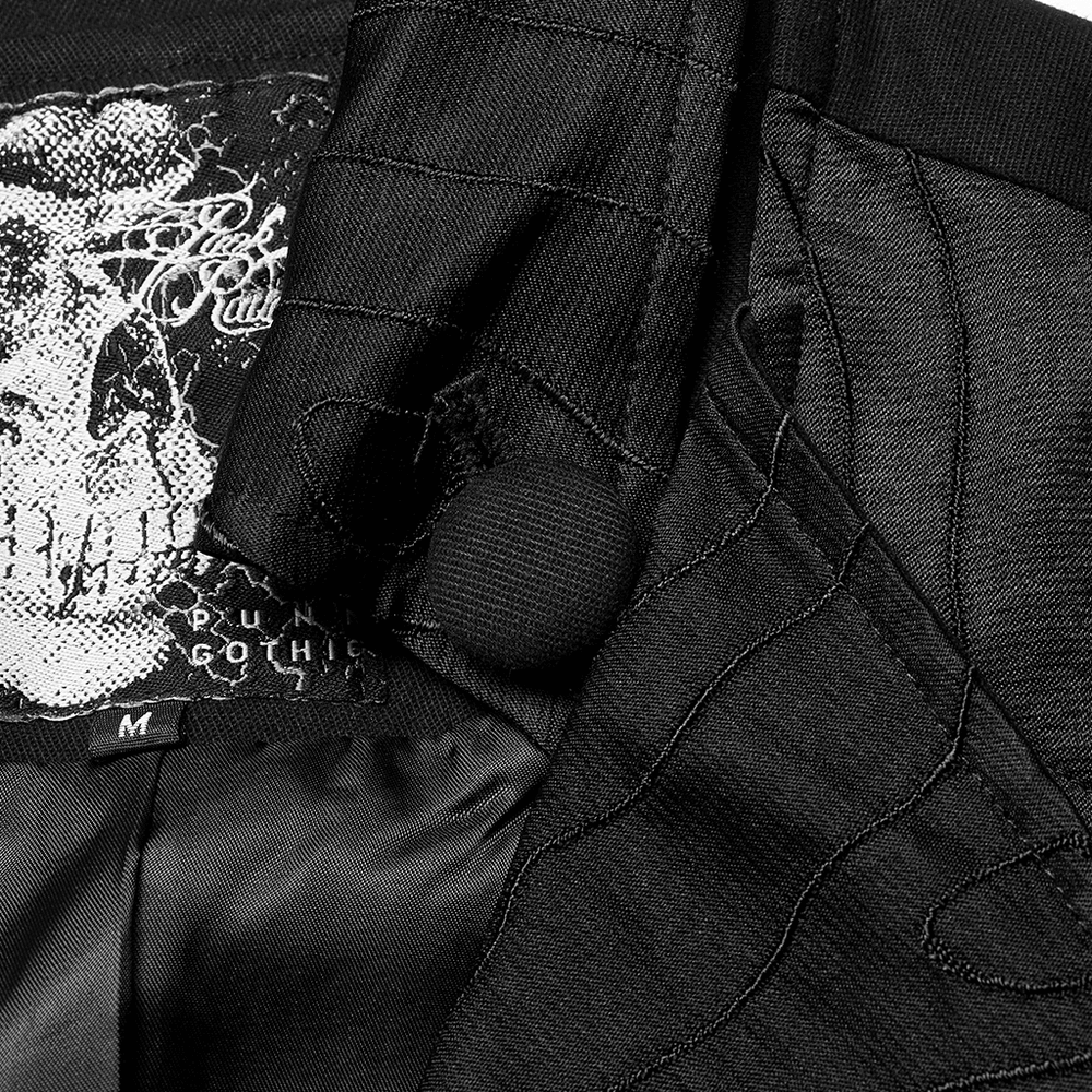 Interior view of a black Victorian Gothic vest showcasing intricate lining and skull print label.