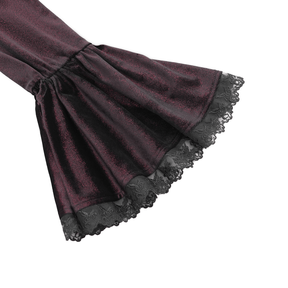 Close-up of the bell sleeves of a Victorian gothic velvet blouse, featuring ruffled edges and intricate black lace trim.