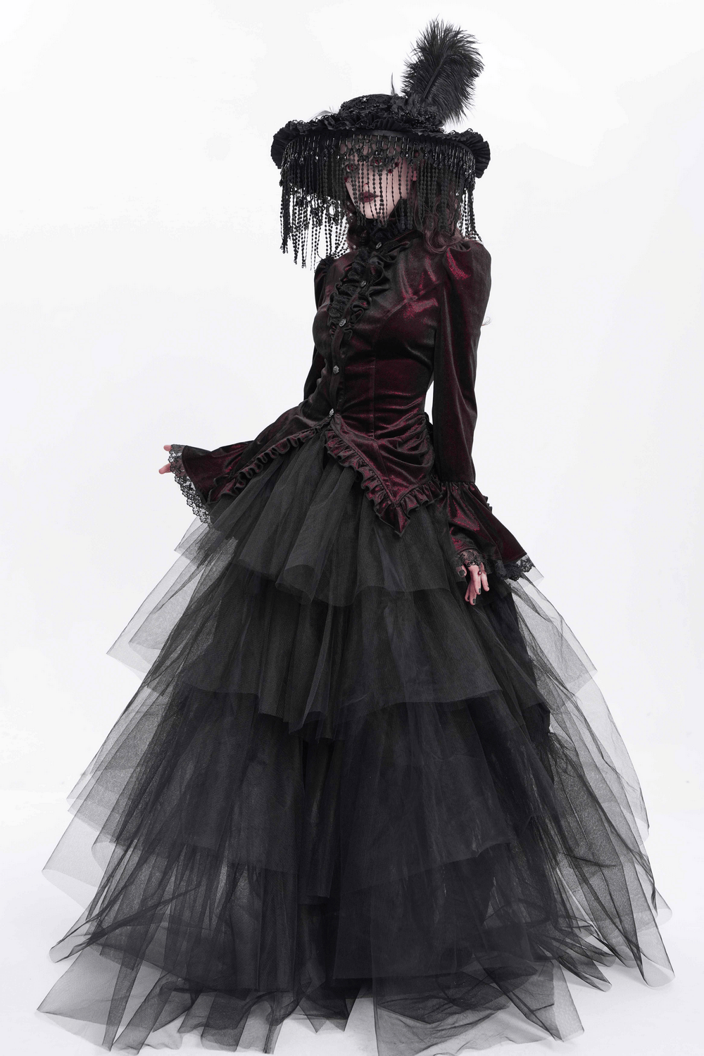 Victorian gothic velvet blouse with lace and corset details, featuring a layered tulle skirt and dramatic hat.