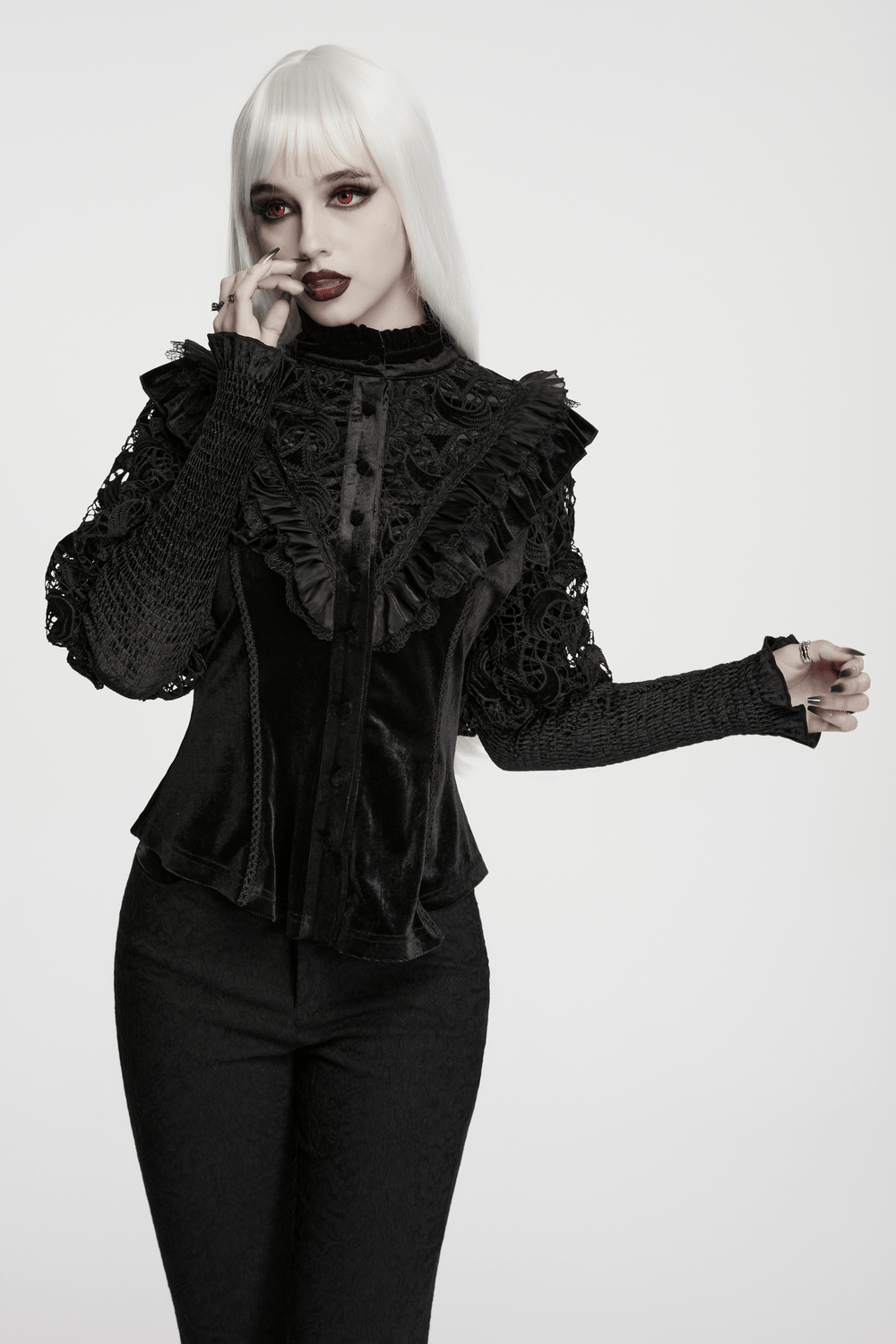 Victorian Gothic Velvet Blouse with Lace Puff Sleeves modeled by a model in a striking pose.