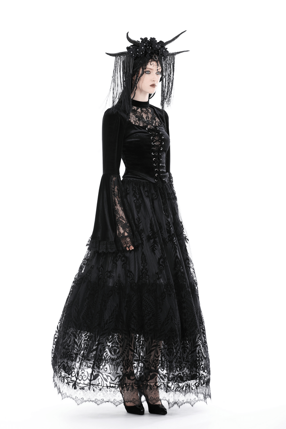 Victorian Gothic style black velvet and lace top with bell sleeves, paired with an elegant flowing black skirt.