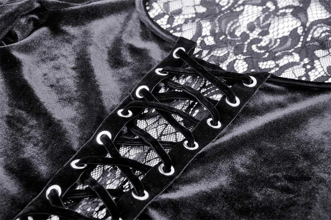 Close-up of black velvet and lace top showcasing intricate lace detailing and stylish lace-up design.