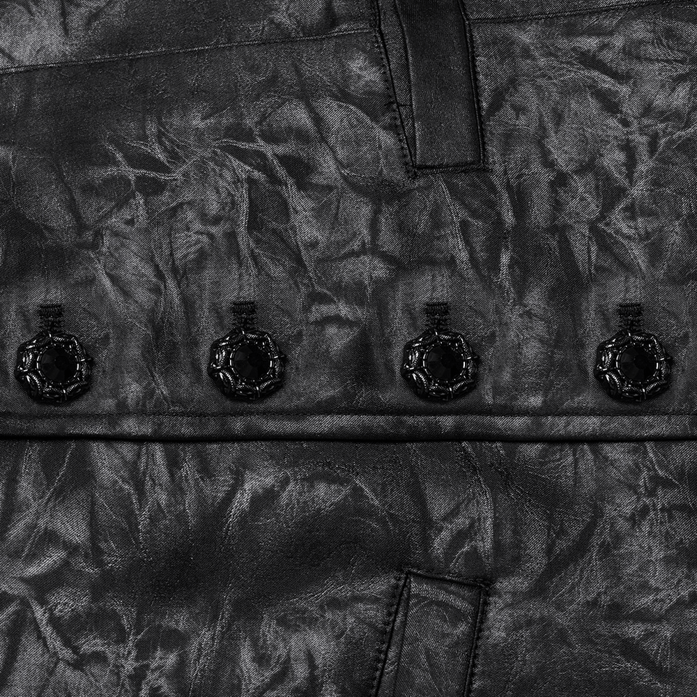 Close-up of the Victorian Gothic vest showcasing hand-sewn carved gemstone buckles on textured jacquard fabric.