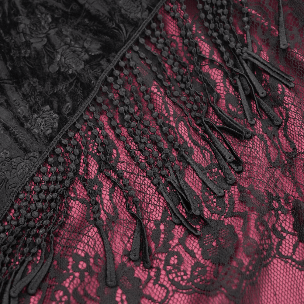 Close-up of Victorian high-waist skirt showing black floral lace and tassel details with deep magenta lining.