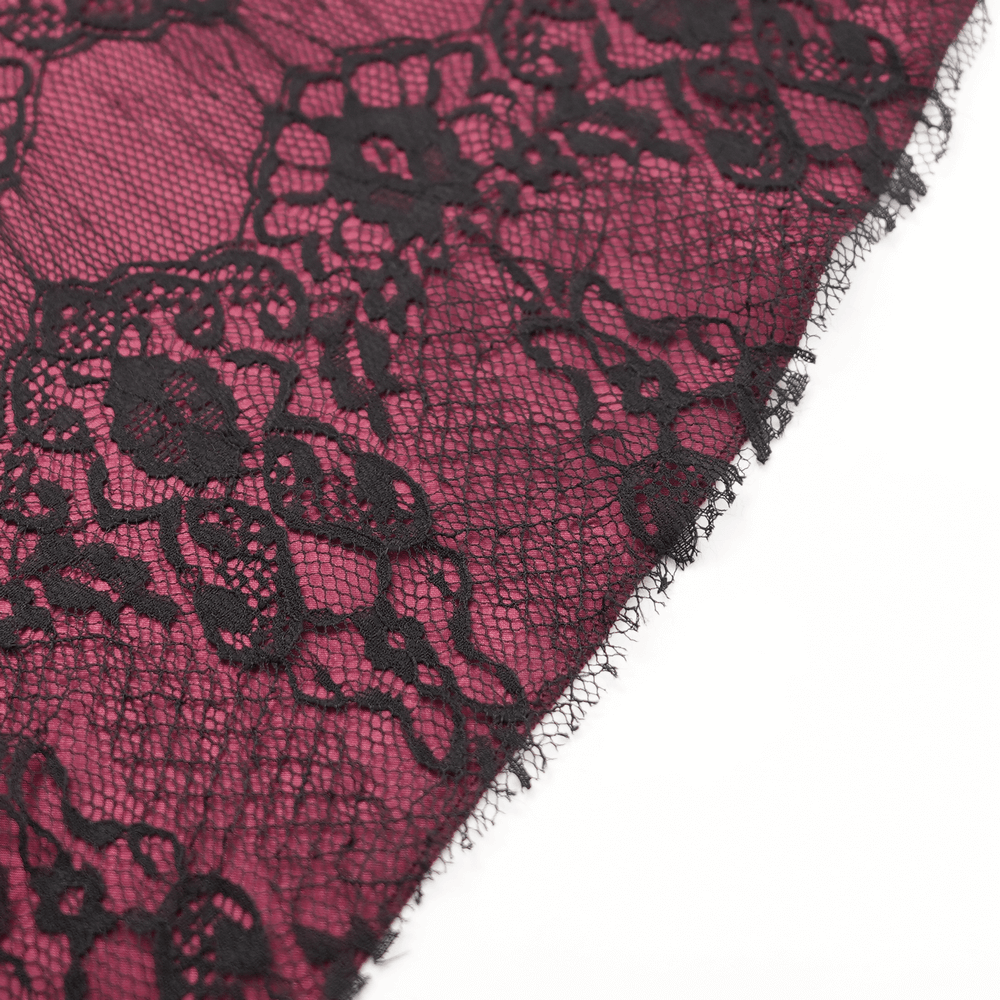 Close-up of black floral lace overlay with deep magenta background, perfect for gothic and Victorian styles.