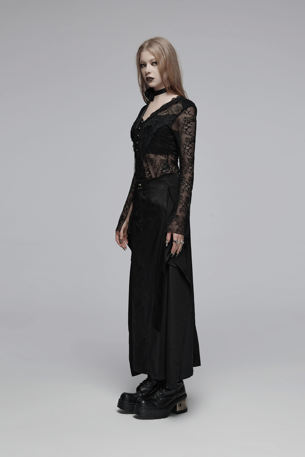 Model wearing a Victorian-inspired black A-line maxi skirt with pockets and lace top, showcasing edgy gothic style.