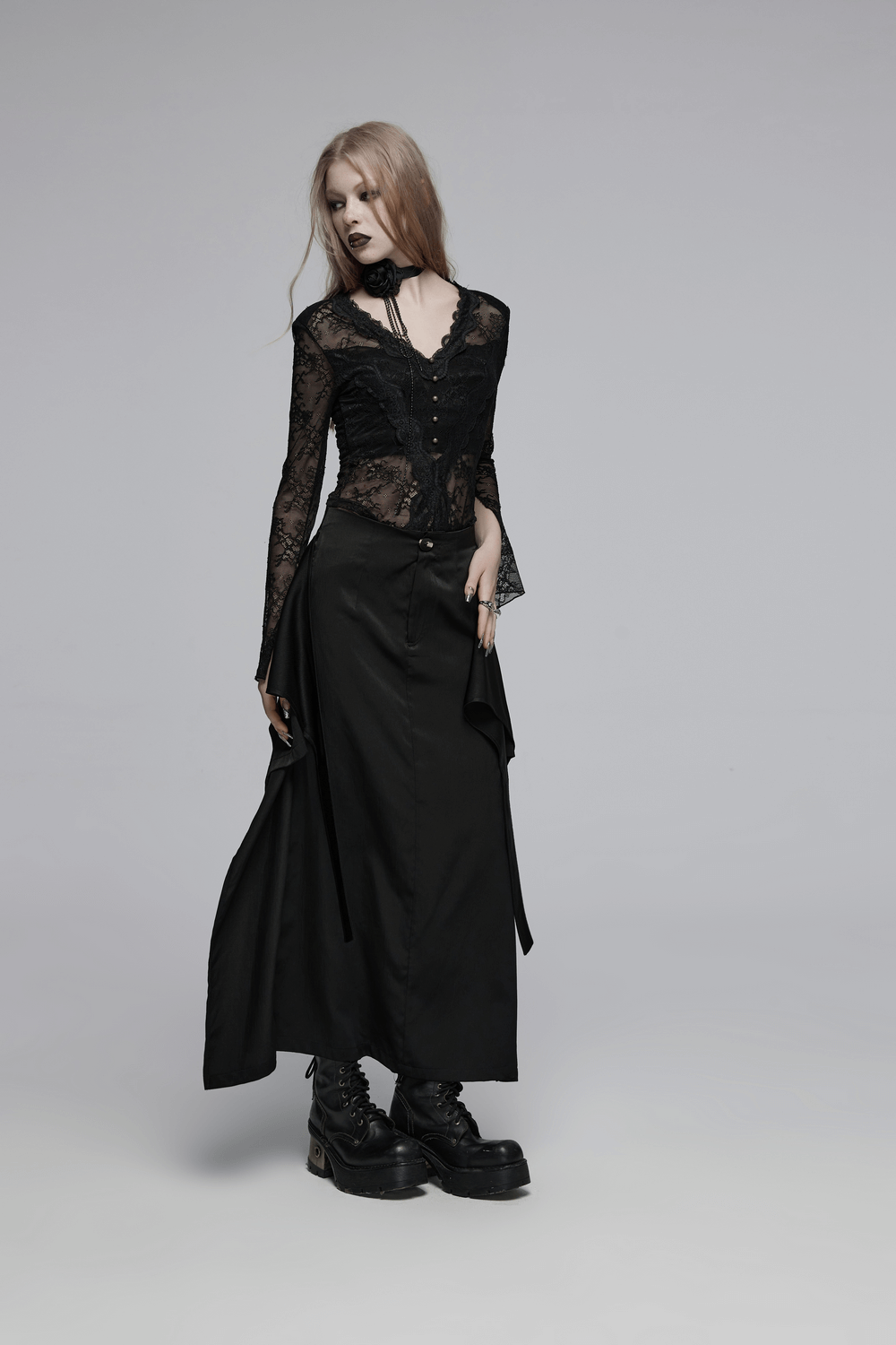 Victorian-inspired black A-line maxi skirt with pockets, paired with a lacy black top and edgy platform boots.