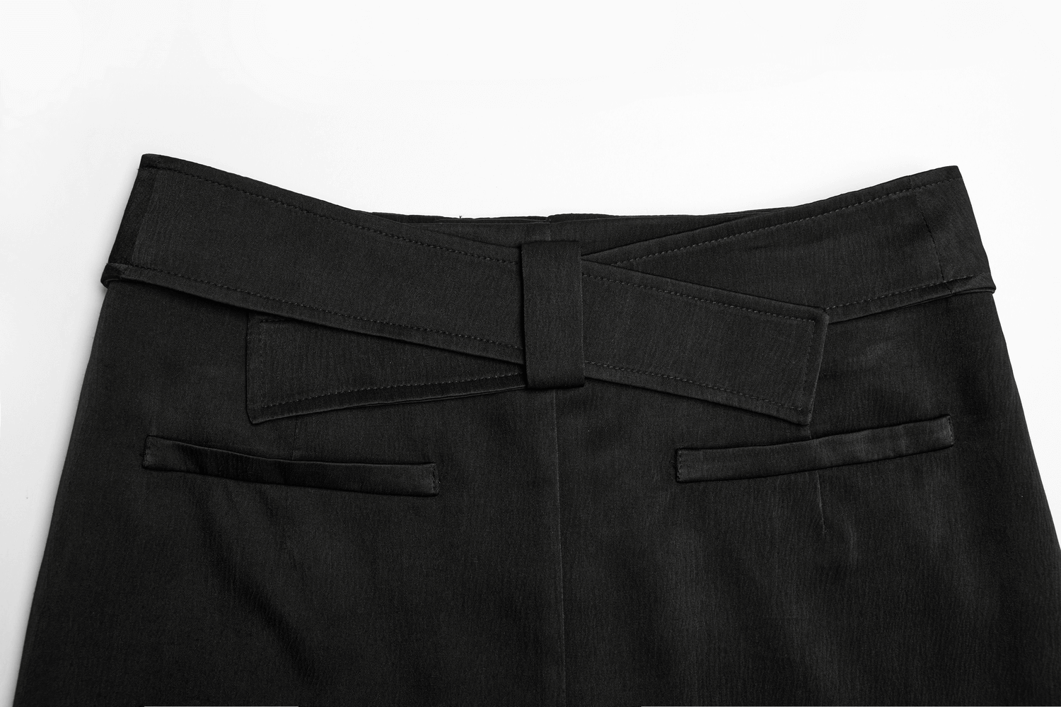 Close-up of the waistband with bow detail of a Victorian-inspired black A-line maxi skirt.