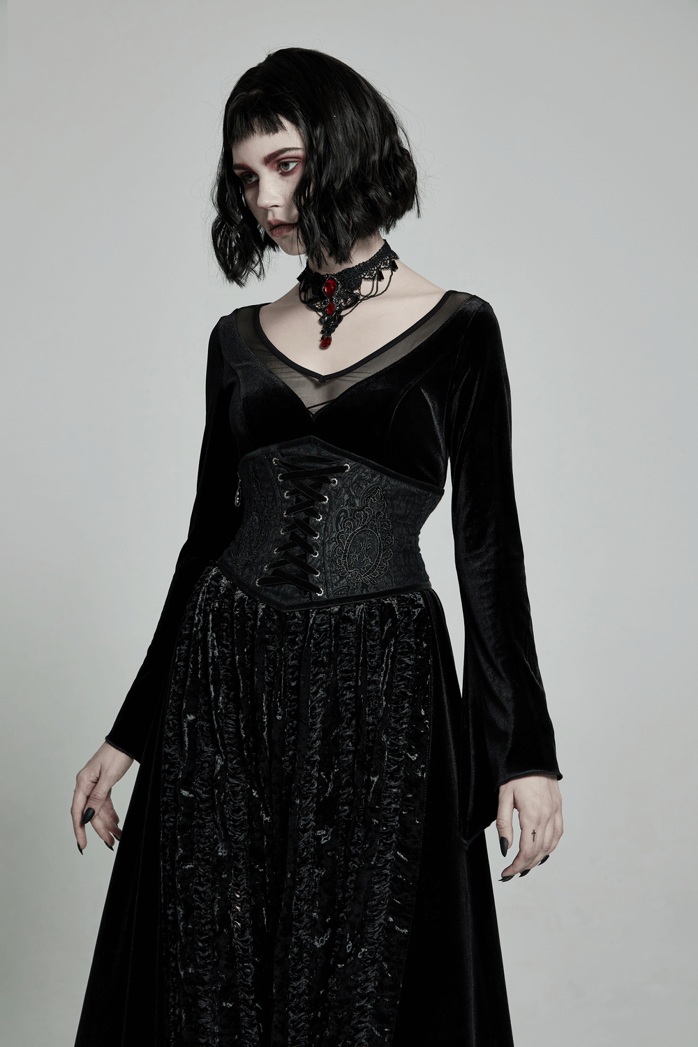 Elegant model in a black Victorian-inspired full corset, featuring lace and intricate detailing, embodying gothic style.