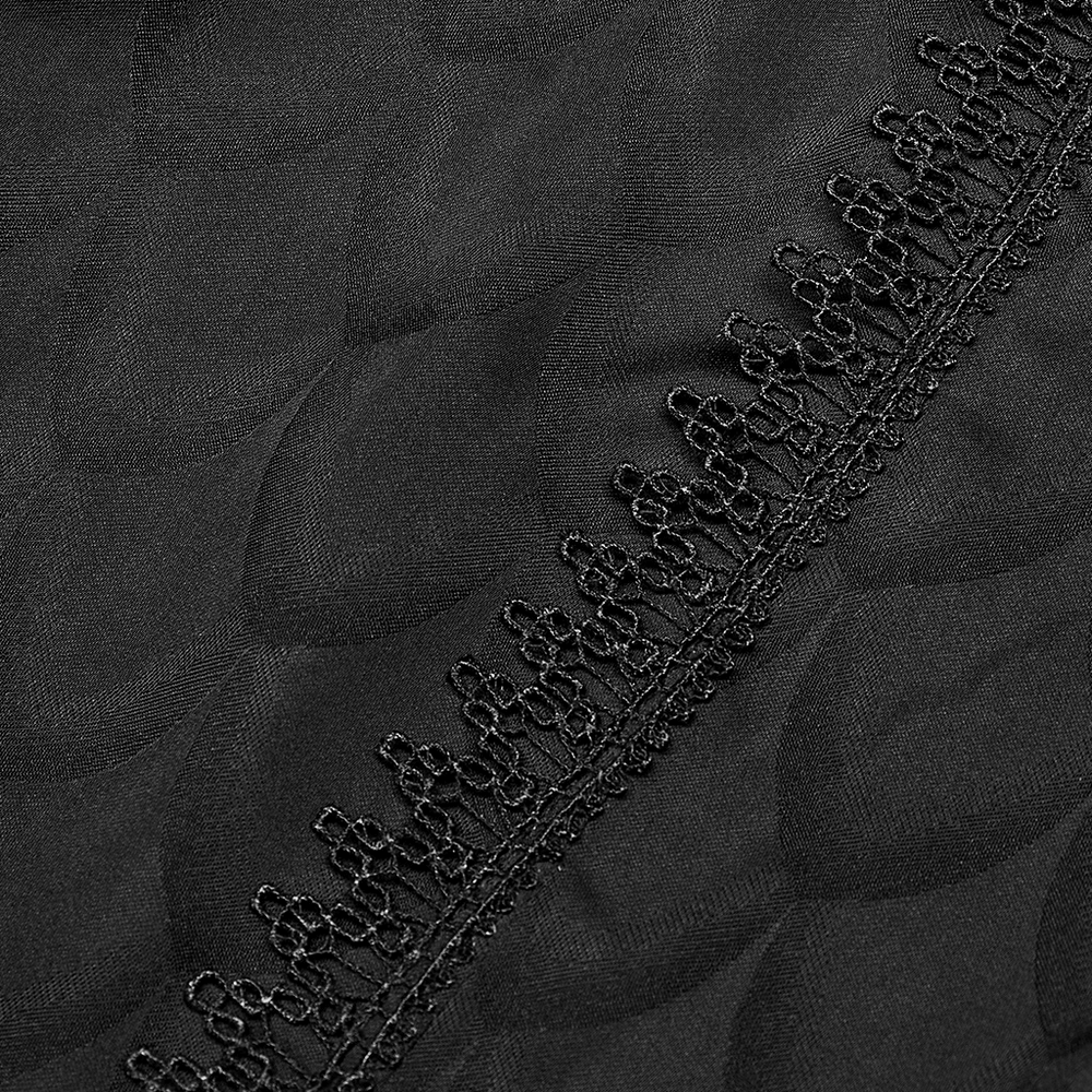 Close-up of black jacquard fabric with intricate lace detailing, showcasing Victorian-inspired elegance.