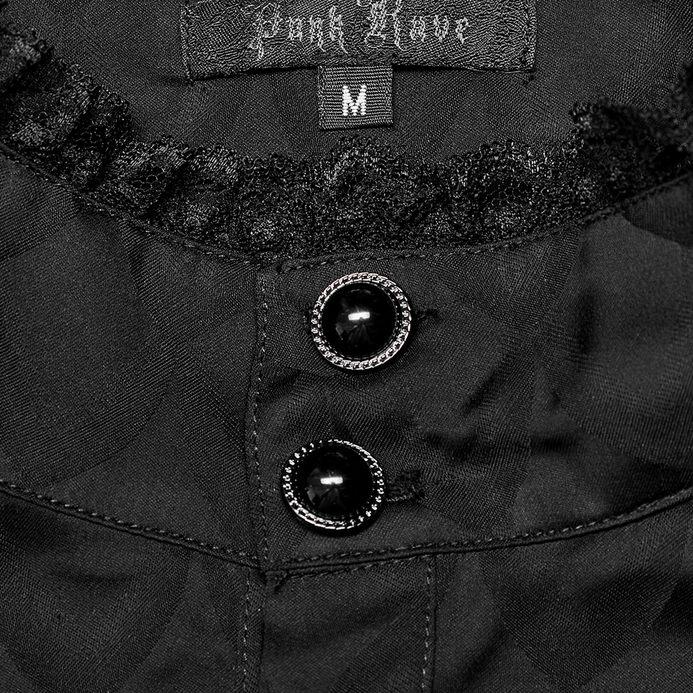 Close-up of black jacquard shirt collar with ruffled trim and decorative buttons, showcasing gothic elegance.