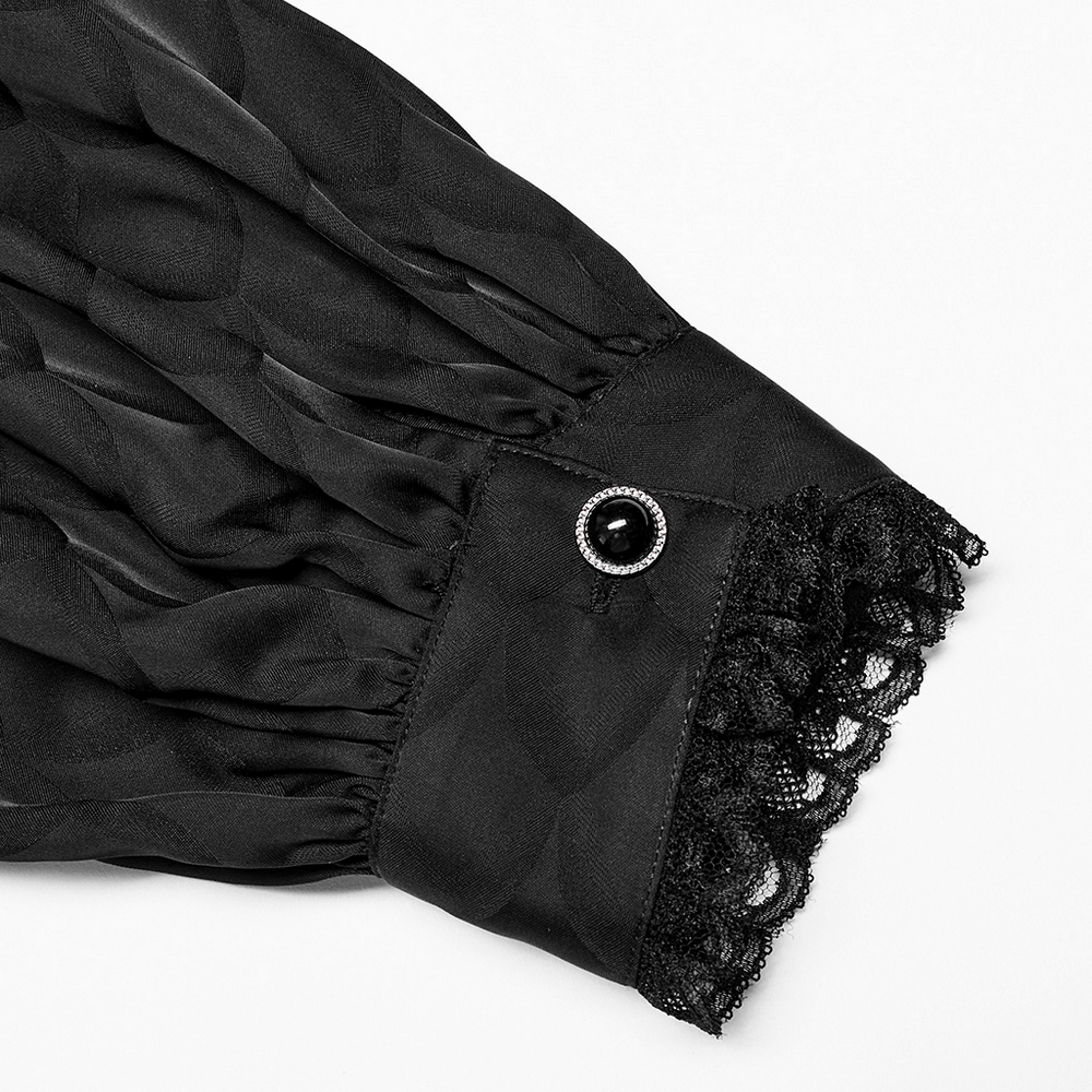 Close-up of Victorian-inspired black jacquard shirt sleeve with lace detail and button embellishment.