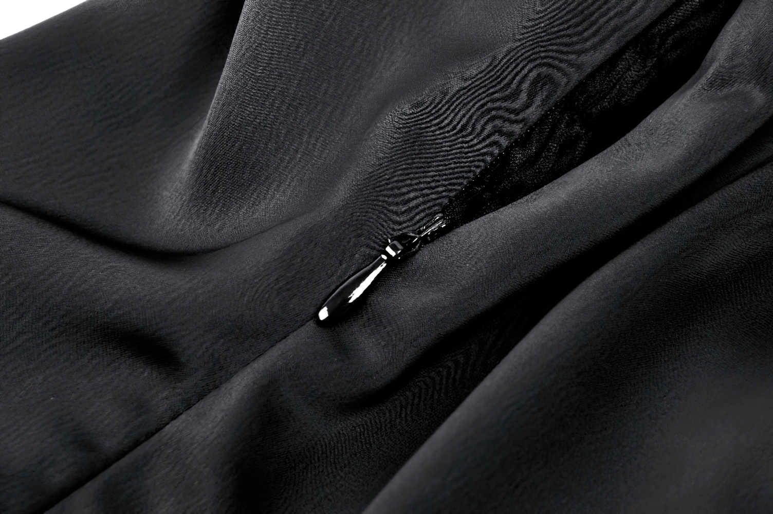 Close-up of a sleek black fabric featuring a concealed zipper detail for a chic look.