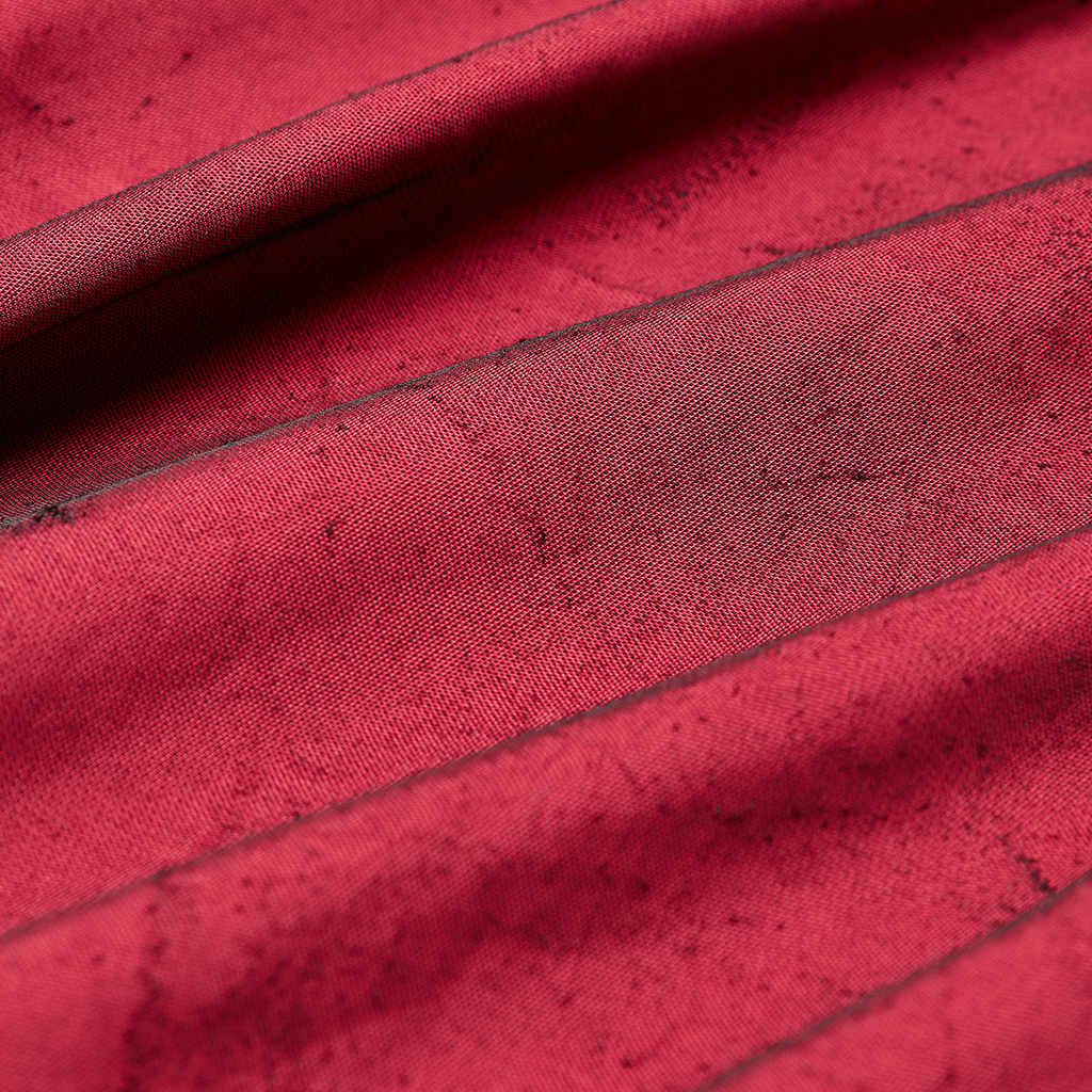 Close-up of rich crimped velvet fabric in deep red, showcasing vintage texture and elegance for gothic fashion.