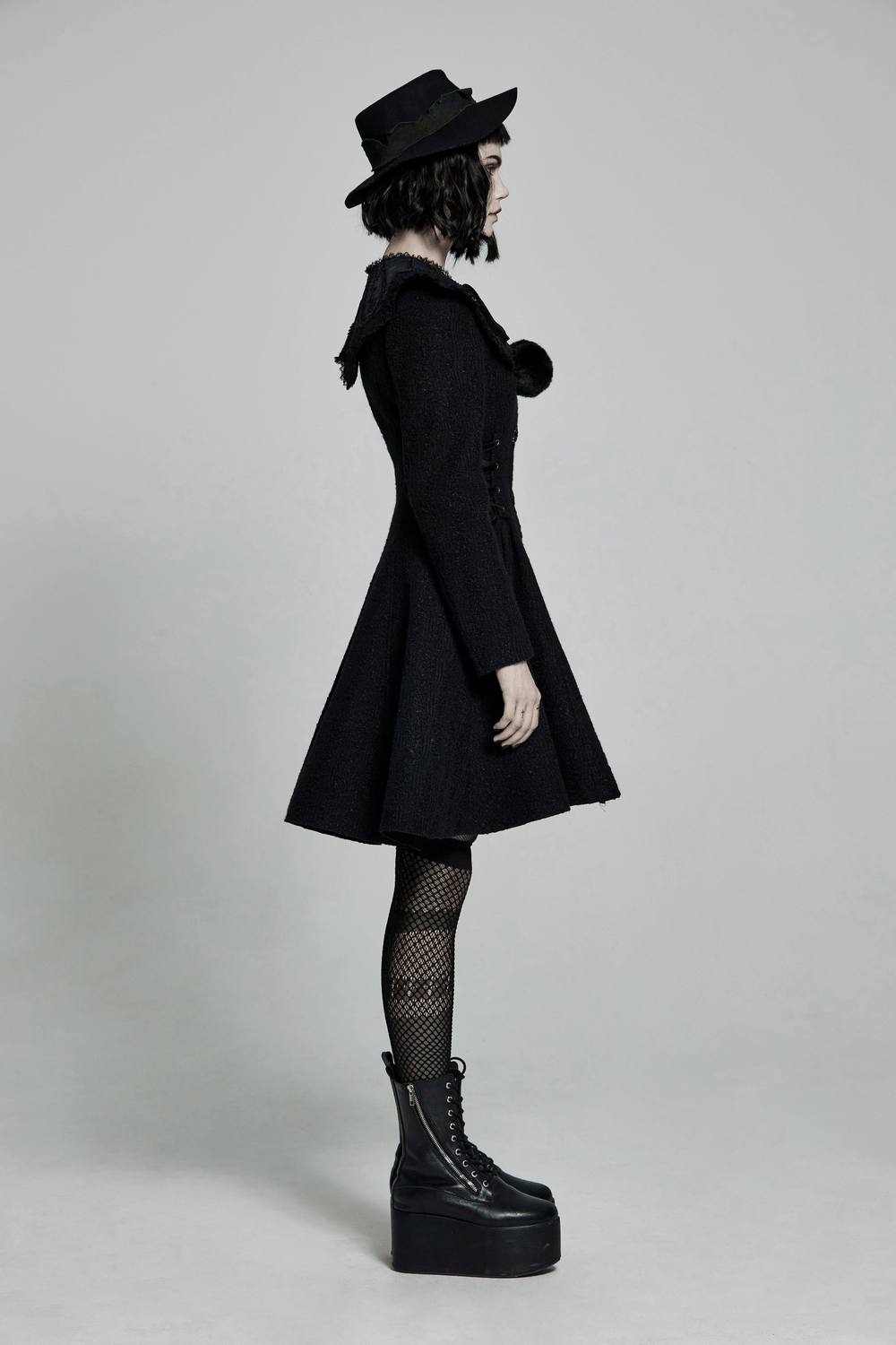 Victorian-inspired detachable fur collar coat in elegant black, worn by a model with gothic accessories and platform boots.