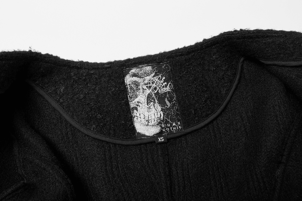 Interior label of a Victorian-inspired goth woollen coat displaying a skull design and size XS.