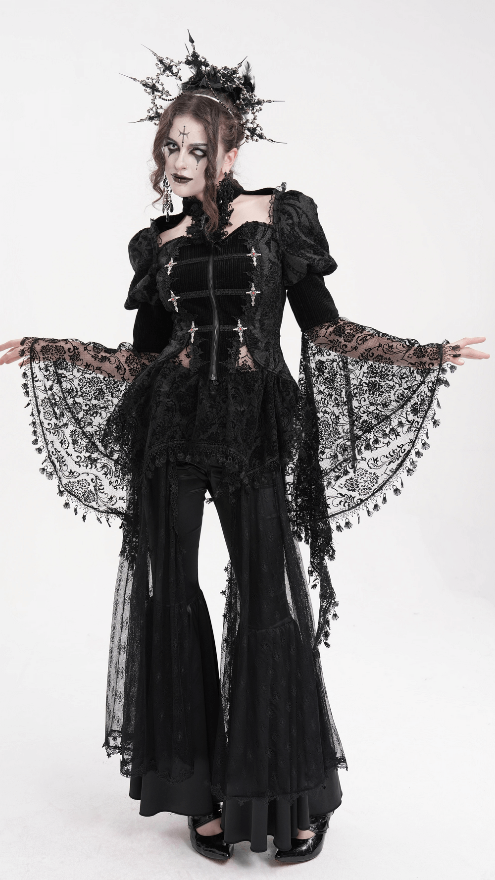 Model wearing a Victorian-inspired Gothic lace blouse with bell sleeves and dramatic bell-bottom pants.