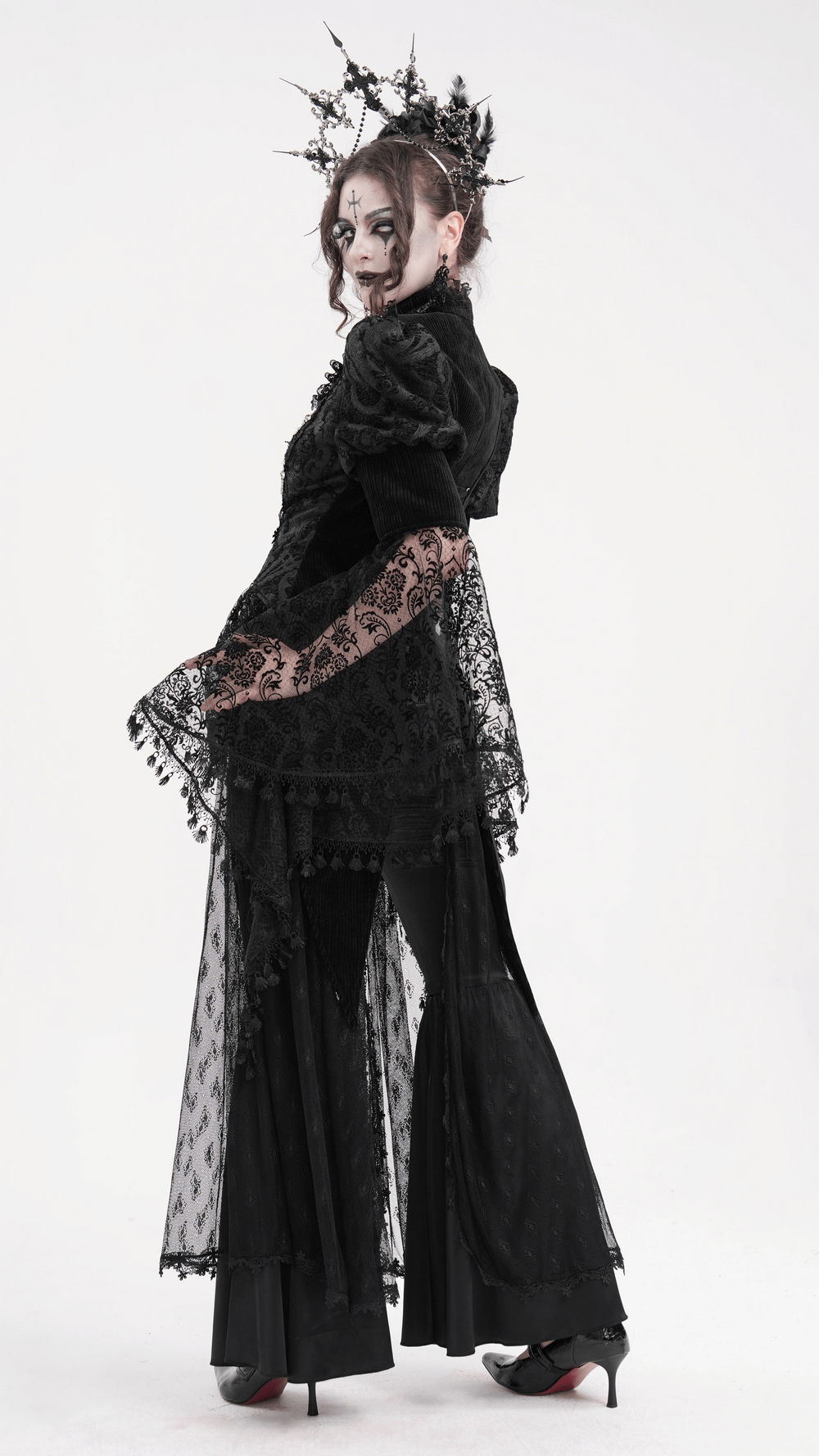 Model showcasing a Victorian-inspired gothic lace blouse with bell sleeves and intricate detailing.