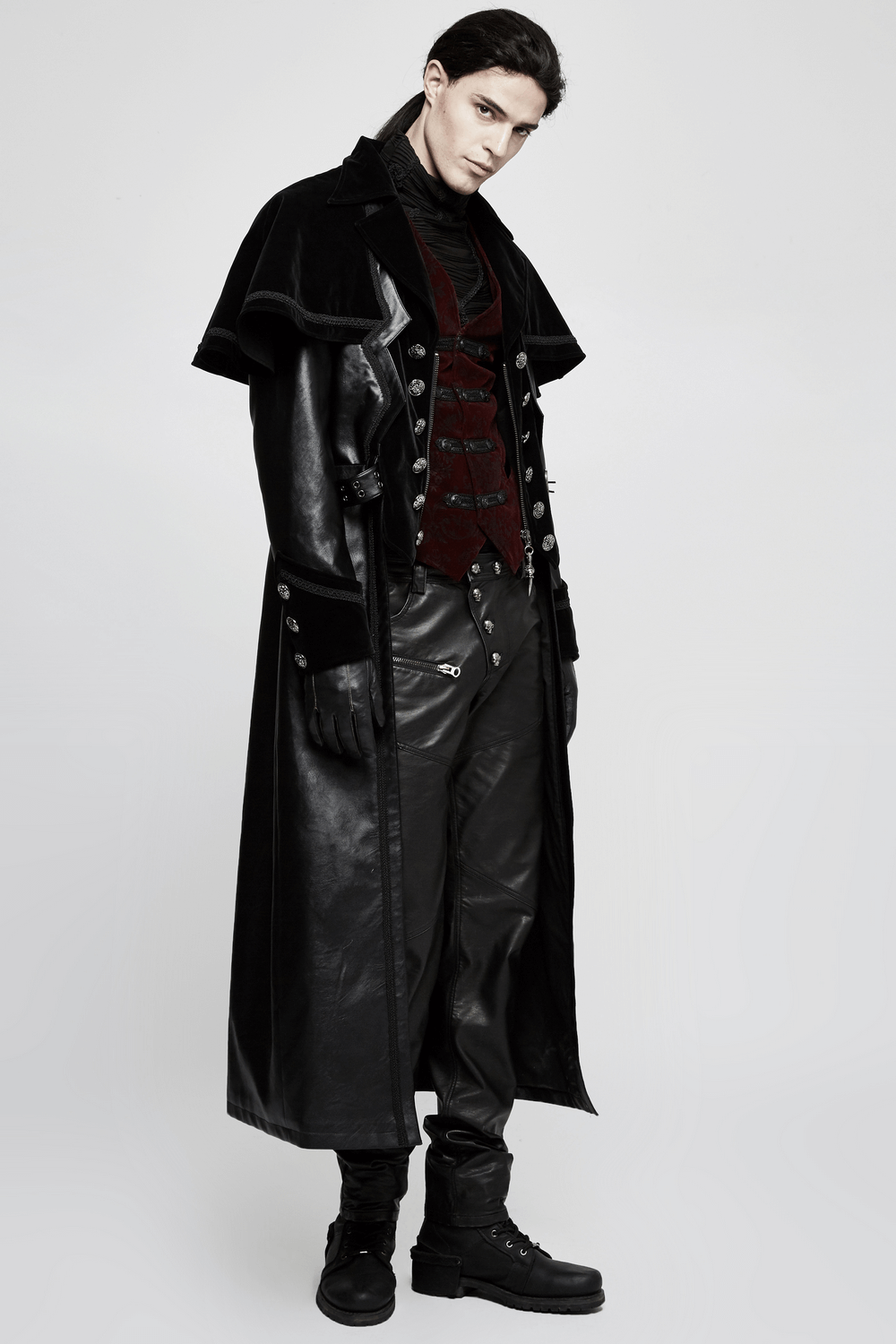 Male model showcasing a Victorian-inspired Gothic velveteen waistcoat and dramatic leather coat.