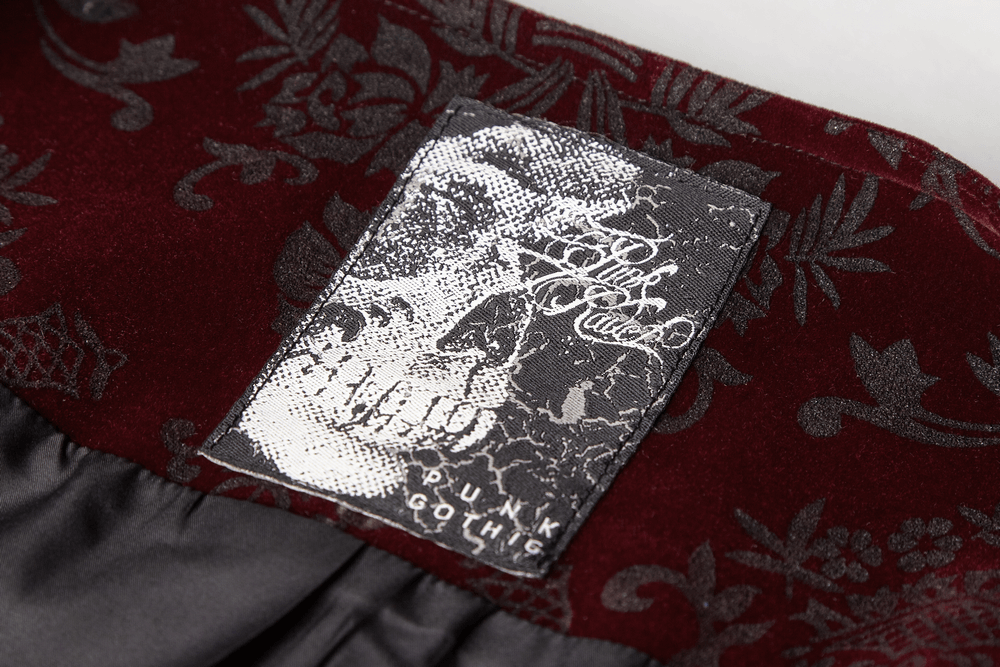 Close-up of the label on a Victorian-inspired Gothic velveteen waistcoat with intricate design.