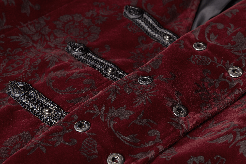 Close-up of a burgundy Victorian-inspired velveteen waistcoat with intricate gothic print and snap buttons.