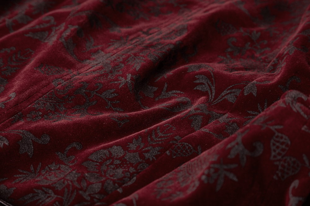 Deep burgundy velveteen fabric with intricate gothic print patterns for a luxurious vintage look.