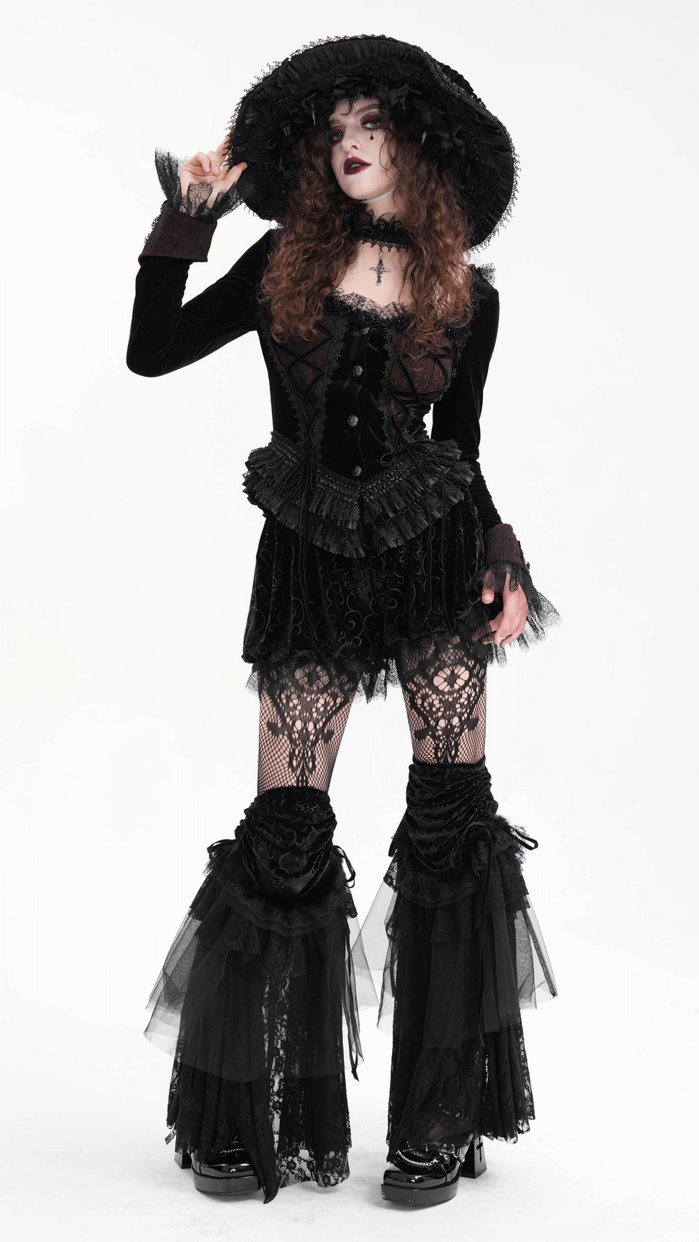 Model showcasing Victorian-inspired lace and velvet layered leg warmers in gothic attire with hat and dramatic styling.