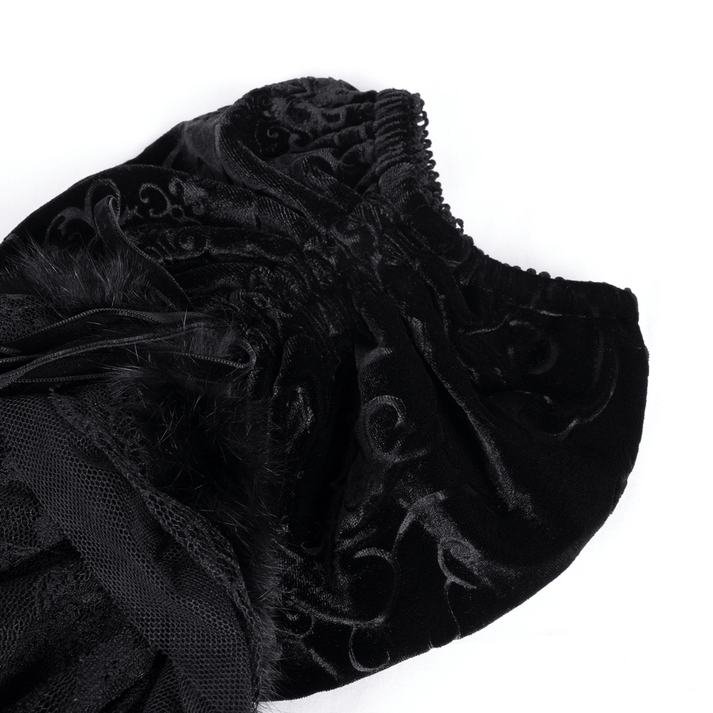 Close-up of Victorian-inspired black velvet leg warmers with lace accents and ruched design.