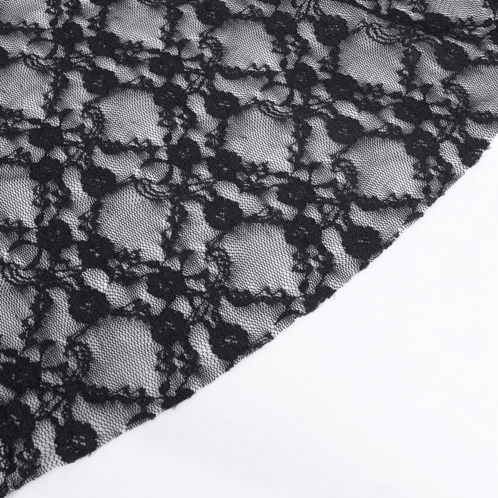 Close-up of intricate black lace fabric with floral patterns, perfect for gothic fashion and elegant designs.