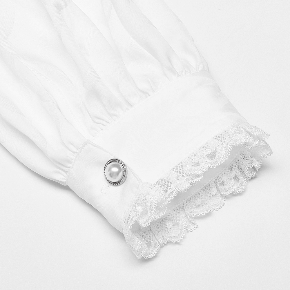 Close-up of Victorian-inspired white shirt cuff featuring lace trim and decorative button.