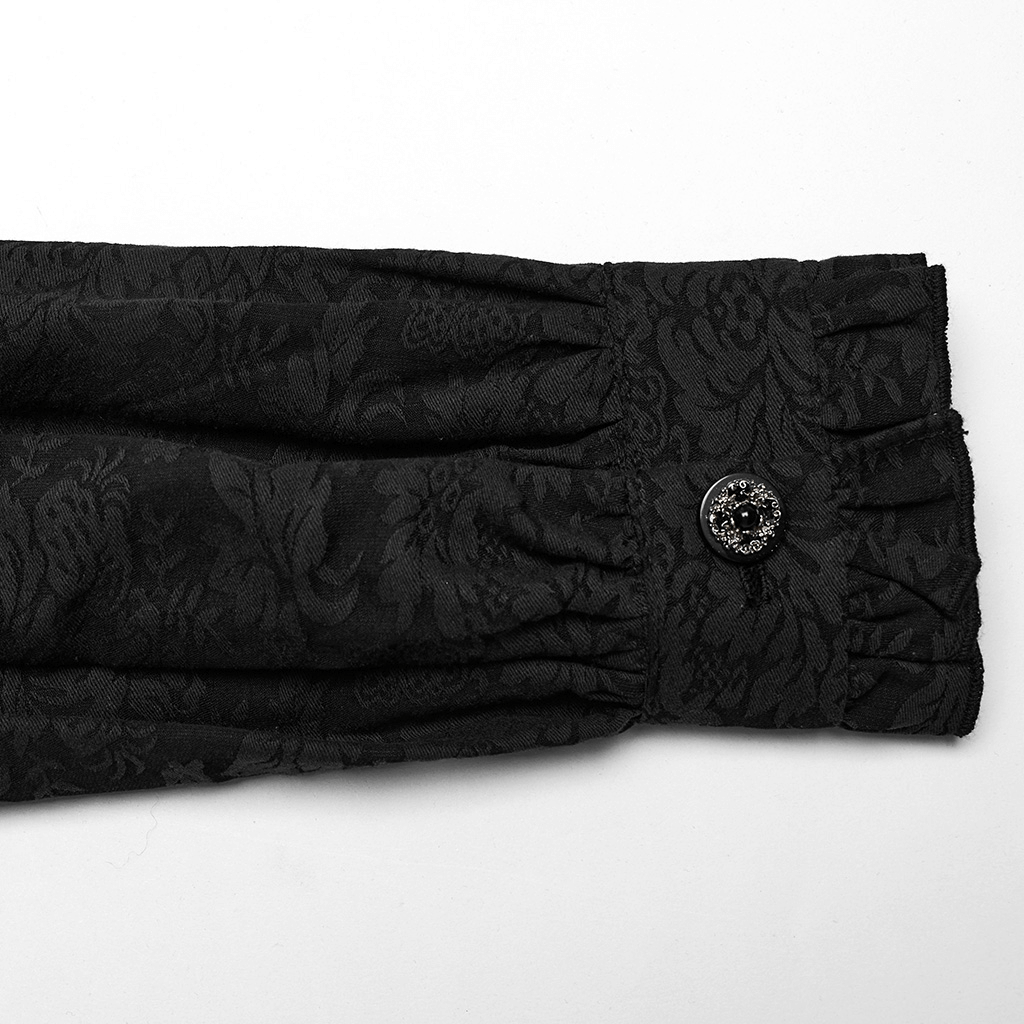 Close-up of black Victorian-inspired blouse sleeve with ruffled trim and decorative button detail.