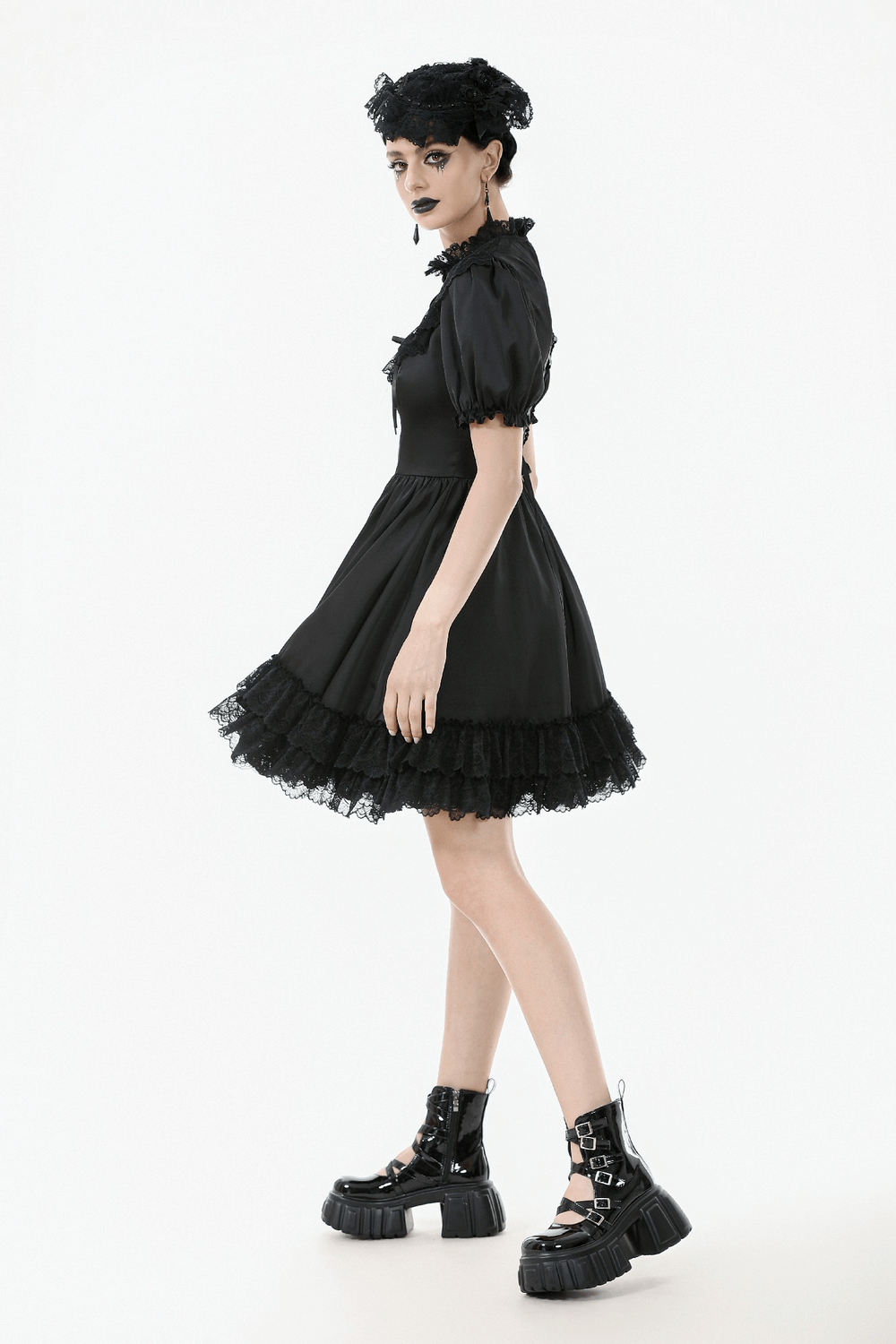 Victorian-inspired black satin dress with ruffled sleeves and lace trim, featuring an elegant Gothic style.