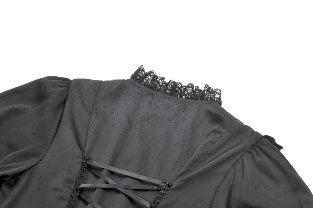 Close-up of the back of a Victorian-inspired black satin dress with lace trim and adjustable ties.