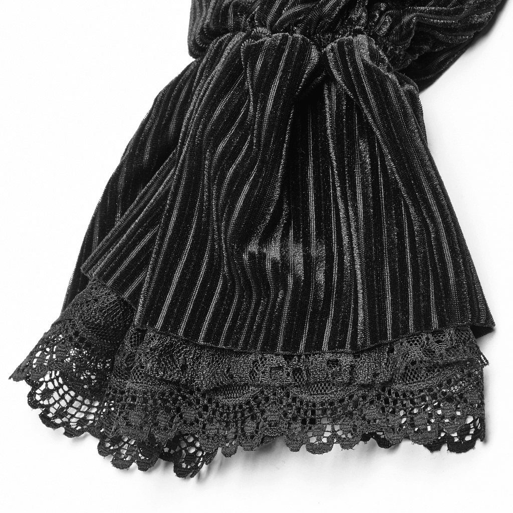 Close-up of striped black velvet fabric with intricate lace detail, showcasing vintage Gothic elegance.