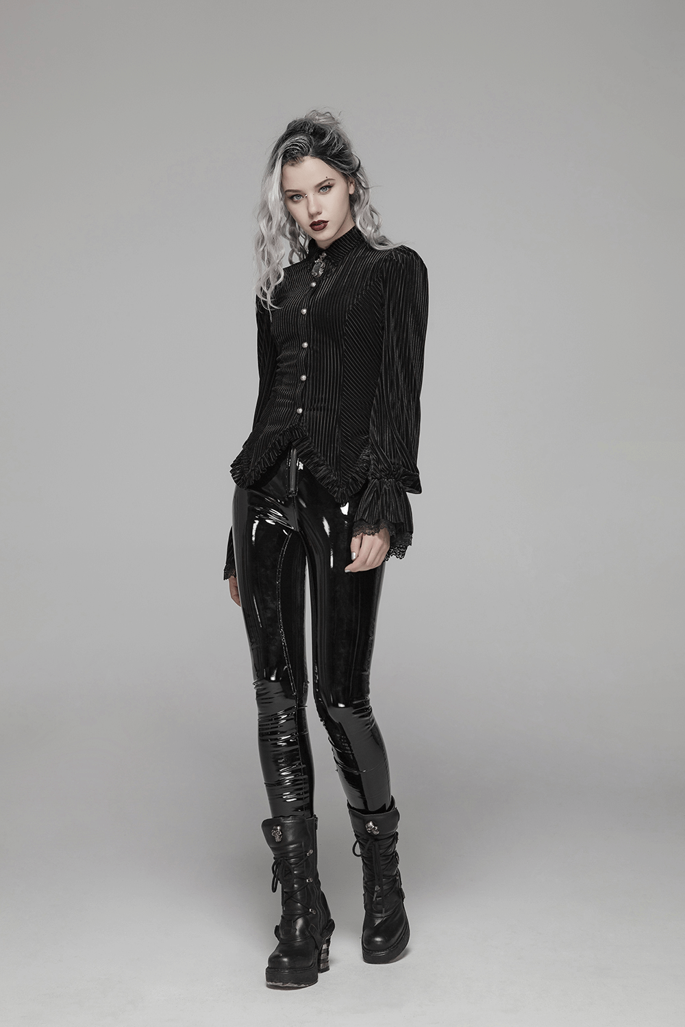 Gothic black velvet corset blouse paired with shiny black latex pants, creating a bold vintage look.