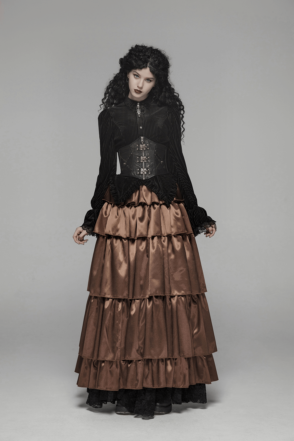 Victorian-inspired gothic black velvet corset blouse with vintage lace detail and layered brown satin skirt.