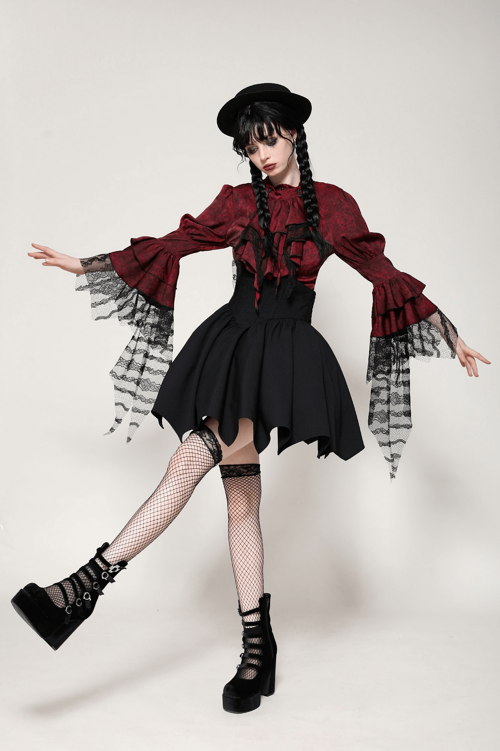 Model showcases a Victorian-inspired wine red and black lace gothic blouse with dramatic ruffles and stylish black skirt.