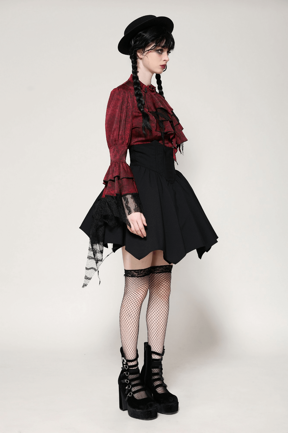 Model showcasing a Victorian-inspired wine red lace blouse, paired with a black skirt and goth accessories for an elegant look.