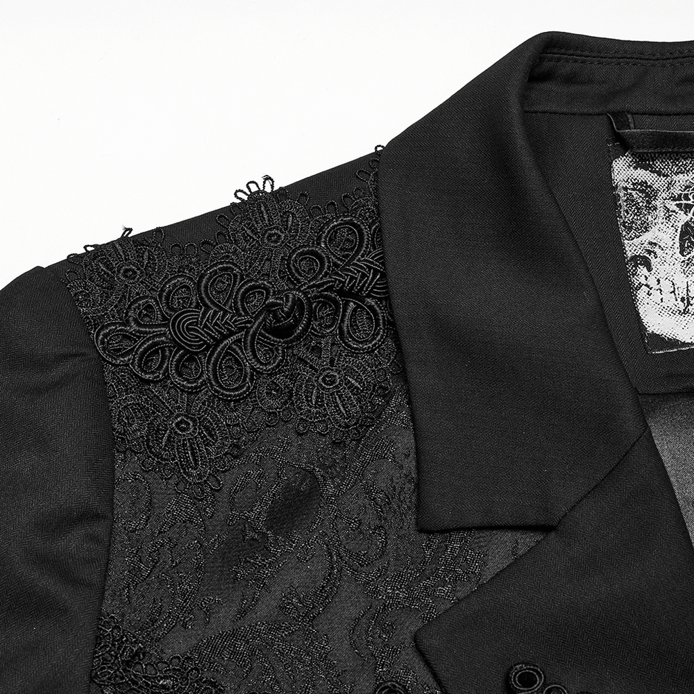 Close-up of Victorian goth men's tailcoat jacket with intricate jacquard and embroidered shoulder details.