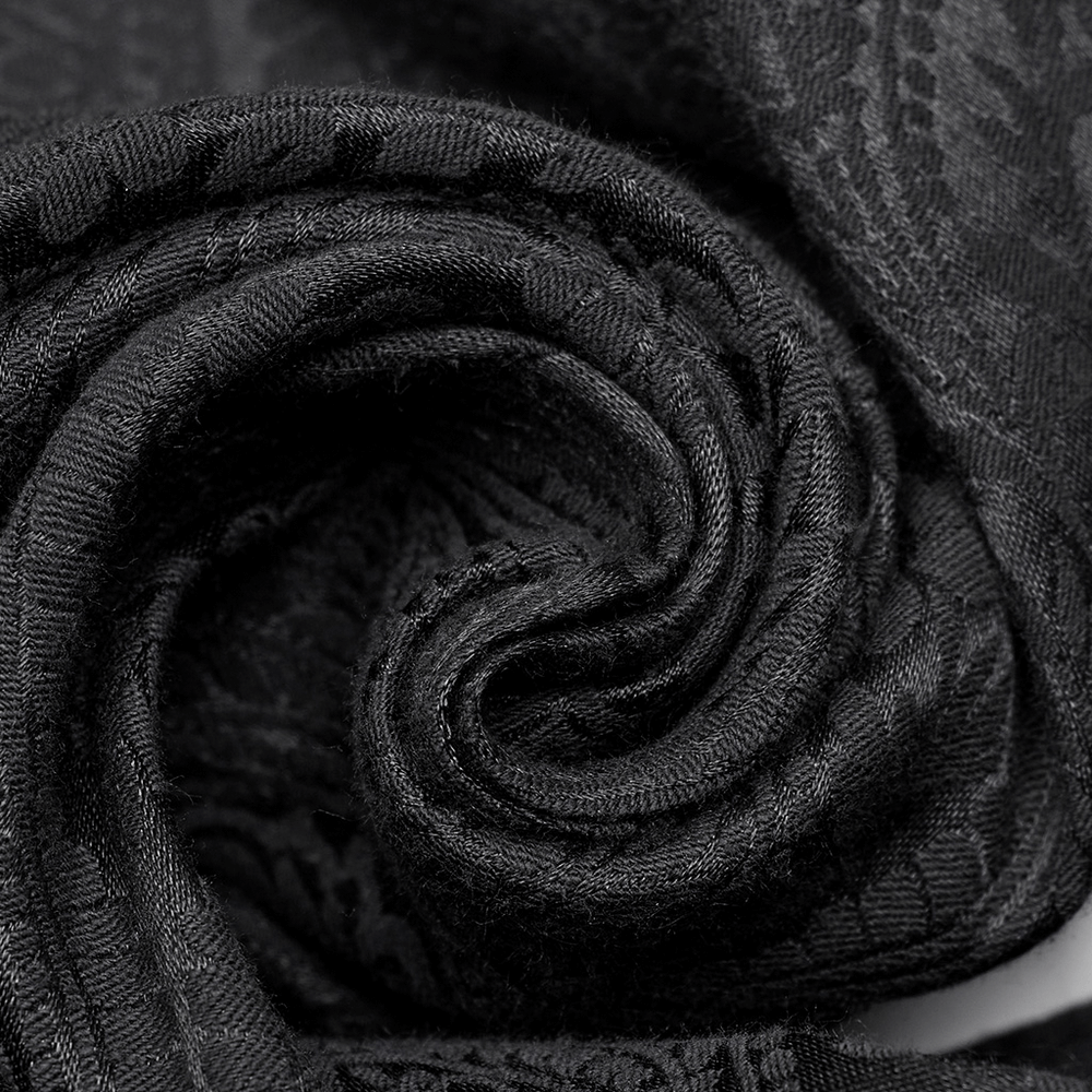 Close-up of luxurious black jacquard fabric, showcasing intricate gothic patterns and a soft, elegant texture.