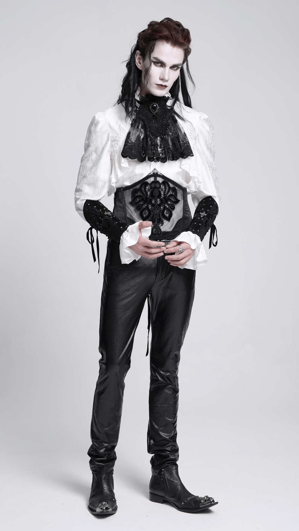 Model in gothic attire with white and black lace collar, embodying Victorian style and dramatic flair.