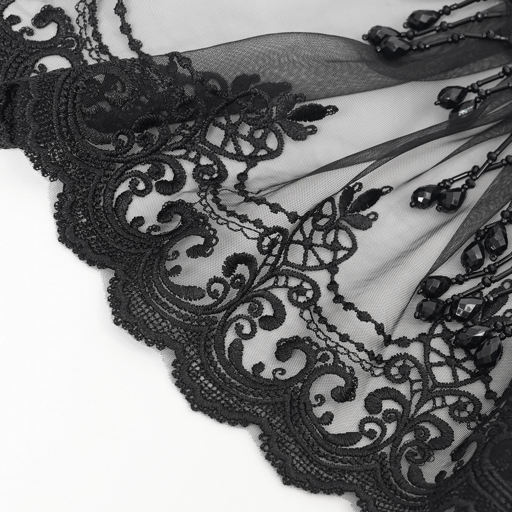 Close-up of a gothic black lace collar with intricate beadwork and elegant embroidery details.